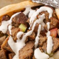 Lamb Gyro · Doner style lamb served in hot pita bread. Served with Tomatoes, lettuce onions, green peppe...