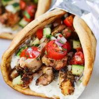 Chicken Gyro · Delicately marinated sliced chicken breasts served in hot pita bread. Topped off with tomato...