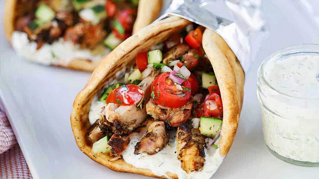 Chicken Gyro · Delicately marinated sliced chicken breasts served in hot pita bread. Topped off with tomatoes, onions, green peppers and lettuce. Served with our house made sauces tzatziki, garlic and hot sauce.