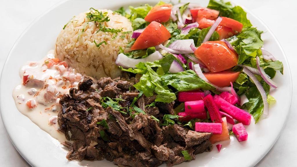 Beef Shawarma Plate · Local beef delicately sliced & seasoned in house. Plate comes with house salad, fresh sauces, hot pita and basmati rice.