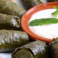 Dolmas · Stuffed grape leaves with rice and spices. Served with house salad and tzatziki sauce.