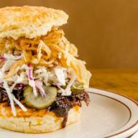 The Elmer 2.0 · Pork belly, BBQ sauce, fried onions, coleslaw + housemade pickles.