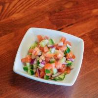 Shirazi Salad 8 Oz · Diced cucumbers, tomatoes, and onions toasted with lemon juice and olive oil.
