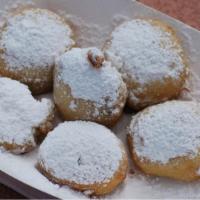 Beignet · Four Cajun doughnuts covered in powdered sugar.