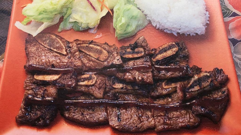 Beef Short Ribs Teriyaki · Grilled beef short ribs with traditional Japanese thick sweet sauce, teriyaki. Comes with steamed rice and salad.