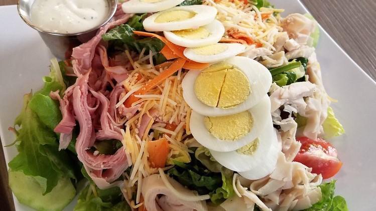 Chef Salad Supreme · Ham, turkey, jack, and cheddar cheese, cucumber, tomato, shredded carrots, hard-boiled egg, on crisp romaine lettuce with ranch dressing.