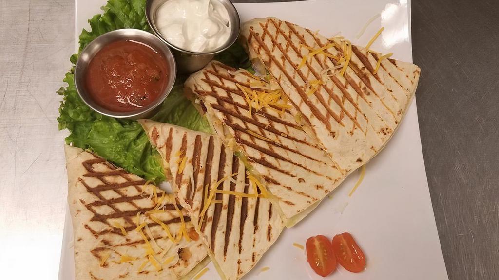 Quesadilla · 5 ounces of grilled chicken breast  in a flour tortilla with pico de gallo, avocado spread, jack, and cheddar cheese. Salsa and sour cream on the side.