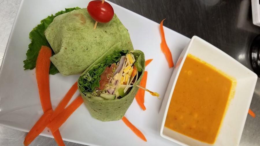 Garden Fresh Wrap · Swiss and cheddar cheese, hummus, cucumber, red, and green bell pepper, lettuce, tomato, red onion, alfalfa sprouts, olive oil, and vinegar on spinach tortilla.