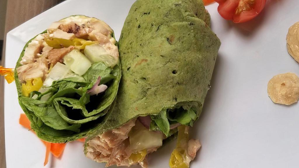 Athens Wrap · 5 ounces of grilled chicken, feta, hummus, cucumber, lettuce, pepperoncini, red onion, and caesar dressing on a spinach tortilla.
