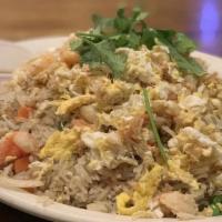 Crab Fried Rice · Stir-fried jasmine rice with egg, onion, pea, carrot 
in light soy sauce. Topped with crab m...