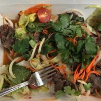 Yum Nua Beef Salad · Grilled sliced beef with onions, tomatoes, cucumbers, cilantro and lime juice dressing. (We ...