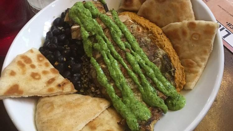 Muscle Bowl · Quinoa, black beans, red pepper hummus, pico, grilled pita, and cilantro lime crema. Vegetarian, vegan, and gluten free.