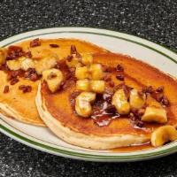 Ban Foster Pancakes · 2 hotcakes topped with caramelized bananas, candied pecans, butter, brown sugar and rum sauce