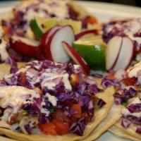 Fish Tacos · Corn tortillas, grilled Alaskan cod, shredded cabbage, crema agria especial, (not mayo), top...