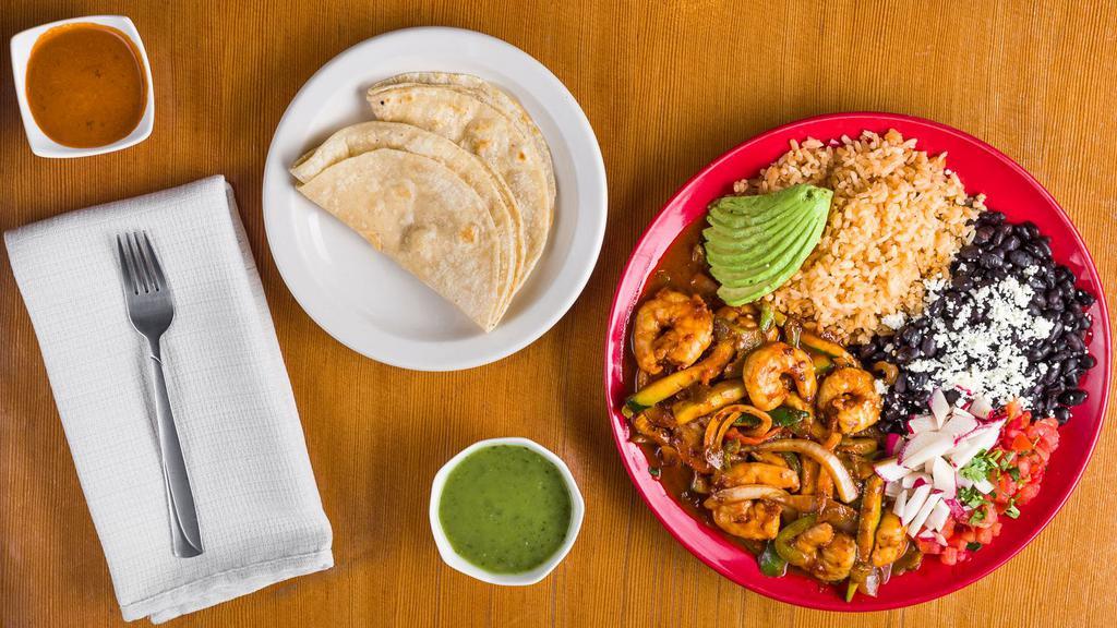 Camarones A La Diabla · Shrimp sautéed in our authentic, hand made, spicy sauce covered in grilled veggies and served with rice, beans, avocado, and tortillas.