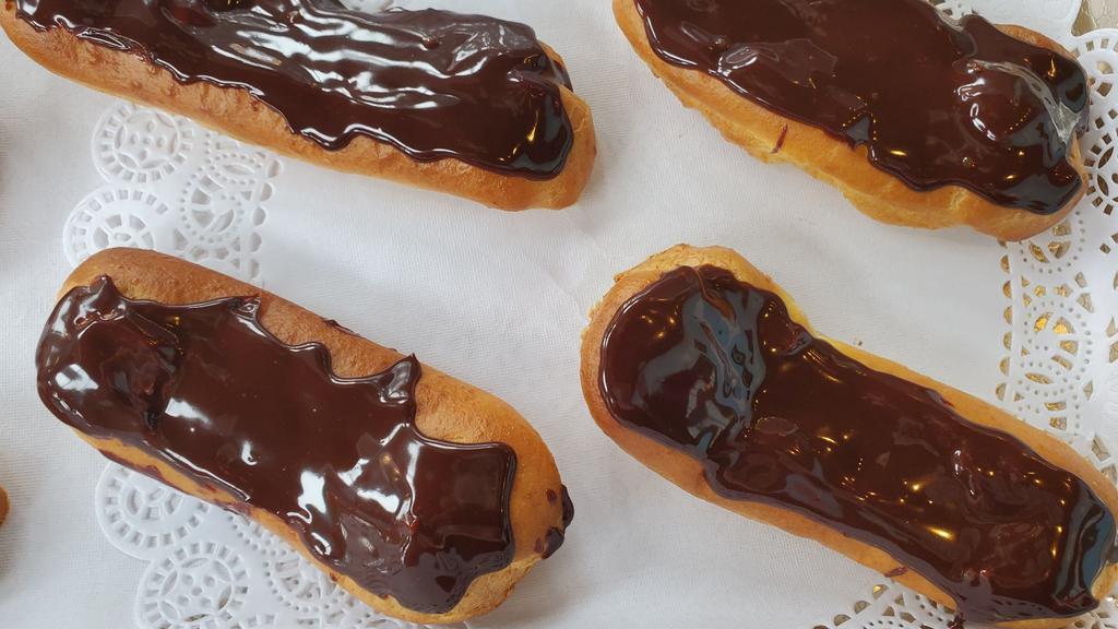Eclair · Our éclair is filled with vanilla custard and topped with dark chocolate ganache. Yuuummm