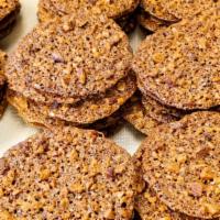 Gluten Free Toffee Crisp · Our signature gluten free cookies. Thin layers of toffee mixed with almonds and pecans and d...