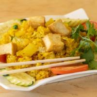 Pineapple Fried Rice · Rice fried with pineapple, onions, yellow curry powder and tofu.