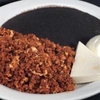 Chorizo Con Huevo · Two scrambled eggs with Mexican chorizo served with re-fried beans, sour cream and tortillas.