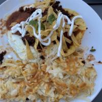 Huevos Rancheros · Crispy corn tortillas layered with black beans, jack cheese, three eggs, ranchero sauce. Top...