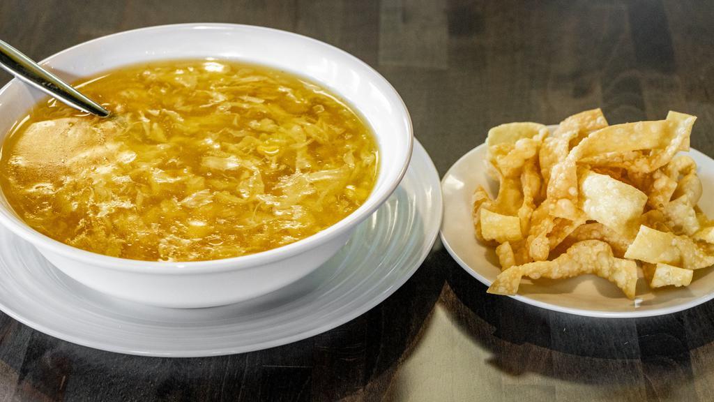 Egg Drop Soup · Velvety broth added with egg and corn.