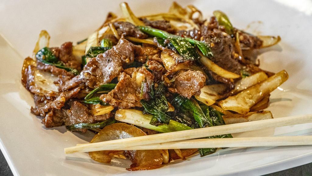 Mongolian Beef · Spicy. Spicy brown hoisin sauce with stir-fried beef, garlic, scallions, and white onions over crispy fried noodles.