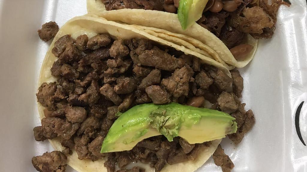 Super Tacos · Double corn tortillas, choice of meat, whole beans, pico, avocado, and cheese.
