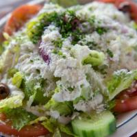 Greek Salad · Romaine, tomatoes, cucumbers, onions, green pepper, garlic sauce, Feta cheese, and olives.