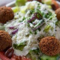 Falafel Salad · Falafel. Served on Greek salad with tahini and Feta cheese.