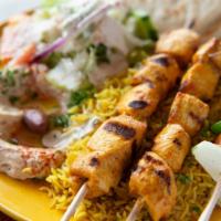 Chicken Kabab Plate · Marinated chicken breast pieces grilled over an open flame and served with rice, hummus, Gre...