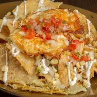 Chilaquiles · Corn Tortilla Chips, Traditional Red Sauce or Tomatillo Sauce, Sour Cream, Cilantro, Onion, ...