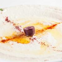 Hummus Bi-Tahini · The original middle Eastern dip of garbanzo beans, tahini sauce, garlic, olive oil, and lemo...
