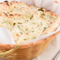 Spinach & Paneer Naan · Leavened bread stuffed with seasoned spinach and homemade Indian cheese.