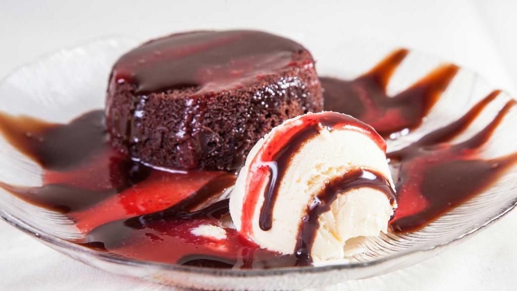 Chocolate Lava Cake · Rich chocolate cake served warm with a liquid chocolate truffle center. Served with vanilla ice cream and drizzled with strawberry puree.
