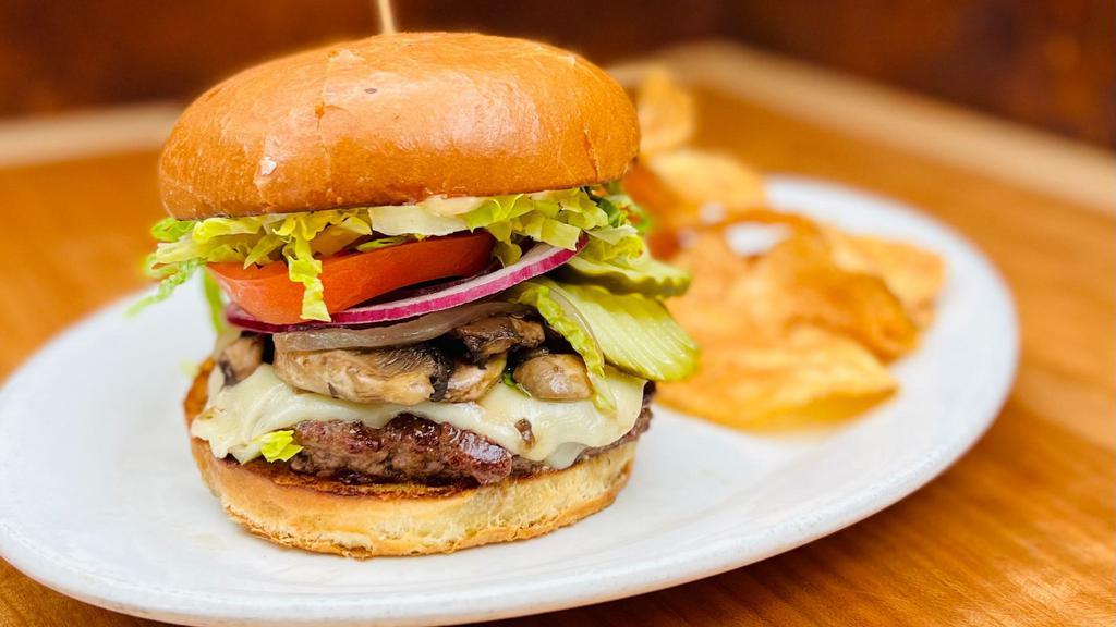 Mushroom Swiss Burger · 1/3 lb Cascade Farms natural beef w/ grilled onions, mushrooms on a brioche bun. Built w/ pickles, tomato, lettuce & burger sauce.  Served w/ house made chips