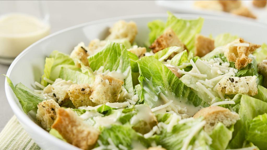 House Caesar · Tossed with our own Caesar dressing with garlic croutons and fresh grated parmesan.