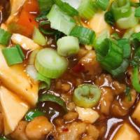 Mapo Tofu · Hot. Soft silken tofu and minced pork stir fried with green onions in a spicy brown sauce.