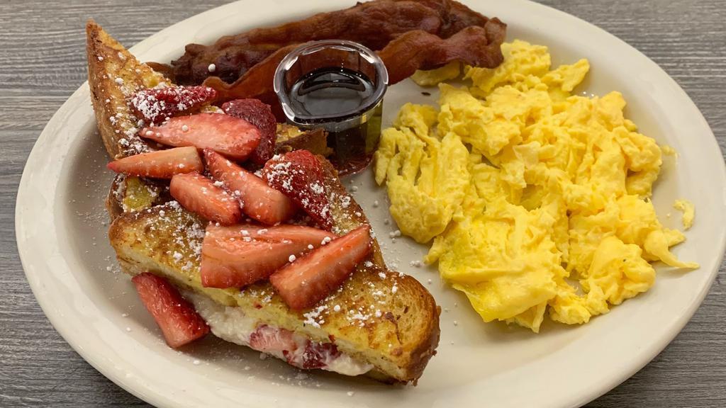 Stuffed French Toast · Two pieces of thick cut French toast bread dipped in our fresh egg batter & grilled to perfection stuffed with a sweet cream cheese & strawberry filling