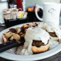 Country Benedict · Our buttermilk biscuit split then topped with sausage patties, two poached eggs & our savory...