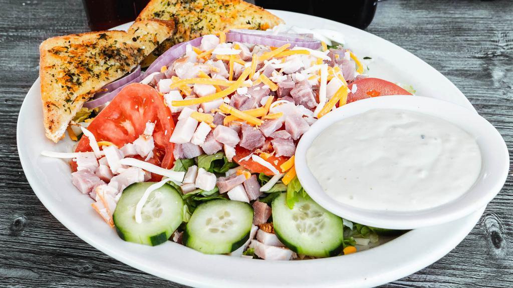Chef Salad · Fresh salad greens, sliced turkey breast & ham, shredded cheddar cheese, topped with sliced red onion, tomato, cucumber & hardboiled egg. Served with choice of dressing.