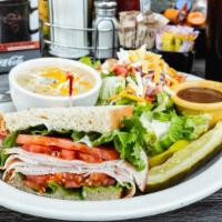 Half Sandwich, Half Salad & Cup Of Soup · Ham, corned beef or turkey on your choice of bread. Topped with lettuce, tomato & mayo. Serv...