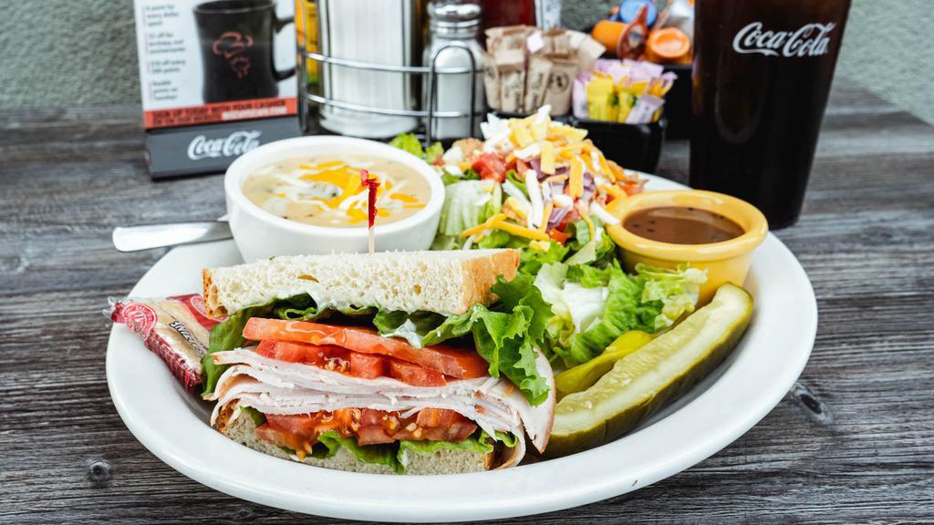Half Sandwich, Half Salad & Cup Of Soup · Ham, corned beef or turkey on your choice of bread. Topped with lettuce, tomato & mayo. Served with a cup of soup or house salad.