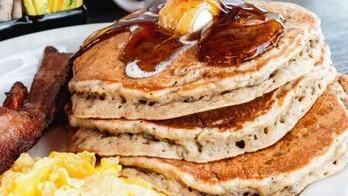 Chocolate Chip Pancakes · Two buttermilk pancakes filled with Ghirardelli chocolate chips and topped with whipped cream and drizzled with chocolate syrup.