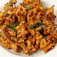 Onion Bhaji · Vegan. Chopped onion mixed with spices and ginger-garlic. Dipped in gram flour batter and de...