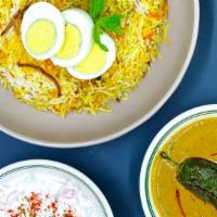 Dum Goat Biryani W/ Mirchi Ka Salan · Long grain basmati rice cooked in a sealed pot layered with goat  and flavored with aromatic...