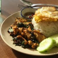 Old Fashion Pad Ka Pao · Thai basil stir-fried with house oyster sauce, served with Thai fried egg sunny side up topp...