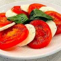 Caprese Salad · Fresh tomato and mozzarella, drizzled with olive oil, salt and pepper, topped with fresh basil