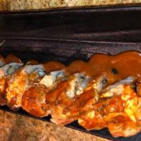 Ninja Roll · Spicy tuna and shrimp tempura topped with spicy crab, soft shell crab, and ninja sauce.