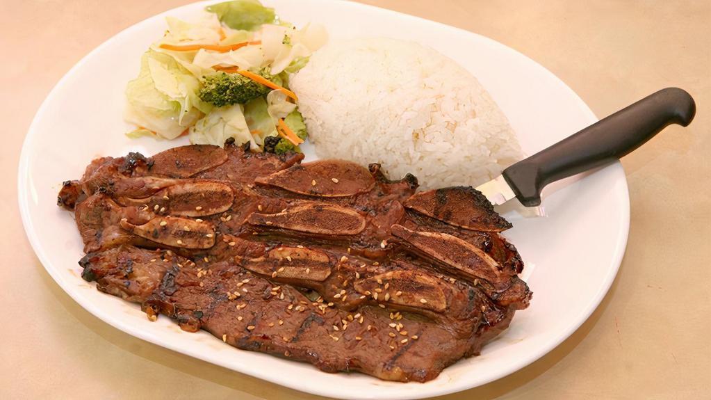 Teriyaki Beef Short Ribs · Beef short ribs marinated and served grilled. Served with steamed rice and stir-fried vegetables.