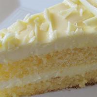 Limoncello Mascarpone Cake · Layers of sponge cake and lemon infused mascarpone cream, decorated with white chocolate cur...